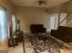 Spacious living room featuring plush leather seating, a fireplace, and neutral walls with carpet at 5327 Yoshino Ter, Powder Springs, GA 30127