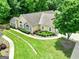 Aerial view of the tan home boasting meticulously kept landscaping and an expansive lawn at 140 Rehobeth Way, Fayetteville, GA 30214