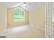 Bright bedroom with a large arched window and neutral carpeting at 140 Rehobeth Way, Fayetteville, GA 30214