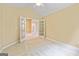 Bedroom with neutral carpet, featuring an open doorway to another room at 140 Rehobeth Way, Fayetteville, GA 30214