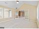 Bedroom with vaulted ceiling and view through French doors to living space at 140 Rehobeth Way, Fayetteville, GA 30214