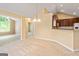 The dining area has neutral carpet, and is adjacent to a kitchen with dark wood cabinets at 140 Rehobeth Way, Fayetteville, GA 30214