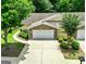 Charming home featuring a two-car garage, stone accents, beautiful landscaping, and a well-maintained driveway at 140 Rehobeth Way, Fayetteville, GA 30214