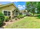 Exterior home view with beautiful lawns, stone accents, and mature trees adding to the landscape at 140 Rehobeth Way, Fayetteville, GA 30214