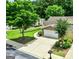 Charming home featuring a two-car garage, stone accents, beautiful landscaping, and a well-maintained driveway at 140 Rehobeth Way, Fayetteville, GA 30214