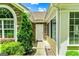 Close-up of front door with stone accents, green foliage, and covered entryway at 140 Rehobeth Way, Fayetteville, GA 30214