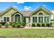Charming home exterior featuring stone accents, many windows, and well-maintained landscaping at 140 Rehobeth Way, Fayetteville, GA 30214