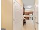 Hallway featuring kitchenette, storage, and access to the front door at 140 Rehobeth Way, Fayetteville, GA 30214