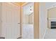 Hallway view through doorway to living area with fireplace and window at 140 Rehobeth Way, Fayetteville, GA 30214