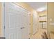 Hallway with closet space leading to a laundry area with washer and dryer at 140 Rehobeth Way, Fayetteville, GA 30214
