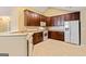 The kitchen has wooden cabinets, white appliances and modern countertops at 140 Rehobeth Way, Fayetteville, GA 30214