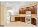 Open kitchen featuring wood cabinets, white appliances, and seamless flow into adjacent living spaces at 140 Rehobeth Way, Fayetteville, GA 30214