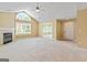Spacious living room with vaulted ceilings, fireplace, large windows, and neutral carpet at 140 Rehobeth Way, Fayetteville, GA 30214