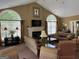 Comfortable living room with a fireplace, large windows, and classic decorations at 140 Rehobeth Way, Fayetteville, GA 30214