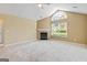 Spacious living room featuring a fireplace, ceiling fan, carpeted floors, and arched window at 140 Rehobeth Way, Fayetteville, GA 30214