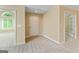 Open room with light colored walls and flooring, with a large door at the far end at 140 Rehobeth Way, Fayetteville, GA 30214