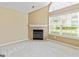 Bright living room featuring a fireplace with tiled surround and large window at 140 Rehobeth Way, Fayetteville, GA 30214