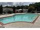 Beautiful community pool with ladders, lounge chairs, and verdant landscaping at 140 Rehobeth Way, Fayetteville, GA 30214
