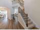 Inviting entryway featuring hardwood floors and a staircase leading to the upper level with views to the living spaces at 236 Villa Grande Dr, Locust Grove, GA 30248
