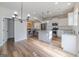 Open kitchen featuring stainless steel appliances, granite countertops, and light wood flooring at 236 Villa Grande Dr, Locust Grove, GA 30248