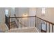 Landing featuring wood railing with iron spindles and staircase at 236 Villa Grande Dr, Locust Grove, GA 30248