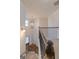 Landing featuring wood railing with iron spindles, staircase, and wood door at 236 Villa Grande Dr, Locust Grove, GA 30248