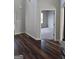 View of a living room with gorgeous wood floors and a connecting doorway to the next carpeted room at 236 Villa Grande Dr, Locust Grove, GA 30248