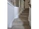 Carpeted stairs with white trim, offer a safe and inviting ascent to the upper level of the home at 236 Villa Grande Dr, Locust Grove, GA 30248