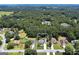 An aerial view of a residential neighborhood featuring well-maintained homes and lush green trees at 35 Deep Springs Way, Covington, GA 30016