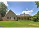 Exterior rear view of house showcasing the roof, siding, porch, and a sprawling green lawn at 35 Deep Springs Way, Covington, GA 30016