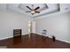 Primary bedroom with tray ceiling and hardwood floors at 35 Deep Springs Way, Covington, GA 30016
