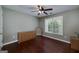 Cozy bedroom with hardwood floors, natural light, and ceiling fan at 35 Deep Springs Way, Covington, GA 30016