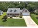 Inviting home featuring a charming front porch, well-manicured lawn, and a convenient two-car garage at 35 Deep Springs Way, Covington, GA 30016