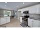Spacious kitchen features stainless steel appliances, granite counters, and adjoining breakfast area at 35 Deep Springs Way, Covington, GA 30016