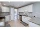 Charming kitchen features granite countertops, tile backsplash, and stainless steel appliances at 35 Deep Springs Way, Covington, GA 30016