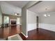 Spacious living room featuring a brick fireplace and dark hardwood floors with a dining room view at 35 Deep Springs Way, Covington, GA 30016