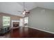 Bright living room with vaulted ceiling, a brick fireplace, hardwood floors, and natural light at 35 Deep Springs Way, Covington, GA 30016