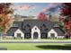 Stunning exterior elevation featuring a stone facade, dark trim, and a beautifully landscaped front yard at 110 Godby Dr, Fayetteville, GA 30215
