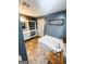 Bathroom features a soaking tub, tile floors, vanity with sink and storage shelving at 225 Second St, Bowdon, GA 30108