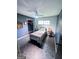 Bedroom features grey walls, unique flooring, ceiling fan and large window offering natural light at 225 Second St, Bowdon, GA 30108