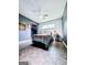 Bedroom features grey walls, unique flooring, ceiling fan and large window offering natural light at 225 Second St, Bowdon, GA 30108