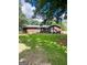 Brick home showcasing manicured front yard with vibrant green grass and blue shutters at 225 Second St, Bowdon, GA 30108