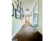Hallway features laminate flooring and walls adorned with framed pictures at 225 Second St, Bowdon, GA 30108