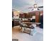 Eat-in kitchen offers dark brown cabinets, a black refrigerator, and an wooden dining table at 225 Second St, Bowdon, GA 30108