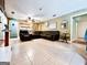 Spacious living room featuring tile floors and a comfortable leather sectional at 225 Second St, Bowdon, GA 30108