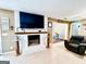 Living room showcasing a white fireplace and a mounted television at 225 Second St, Bowdon, GA 30108