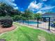 Backyard pool area enclosed by a black metal fence on a sunny day at 225 Second St, Bowdon, GA 30108
