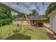 Expansive backyard featuring a large swing set and a covered patio with a grill at 527 Malcom Rd, Covington, GA 30014