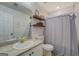This bathroom is equipped with a sink, toilet and shower with grey shower curtain at 527 Malcom Rd, Covington, GA 30014