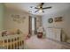 Comfortable Bedroom with white crib, changing table and soft patterned rug at 527 Malcom Rd, Covington, GA 30014